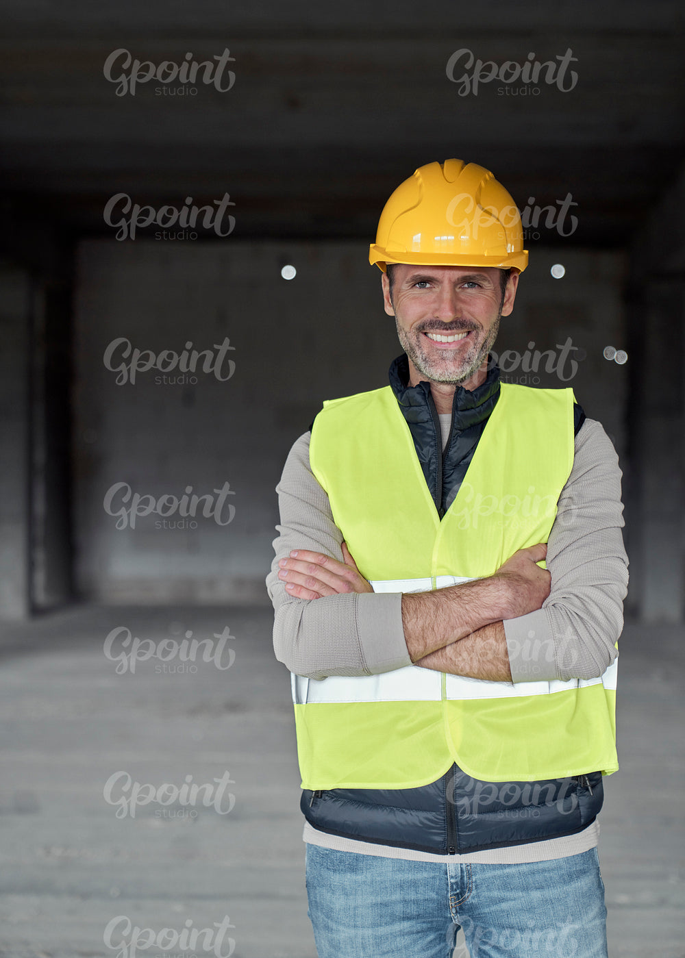 Vertical portrait of caucasian engineer standing on construction site