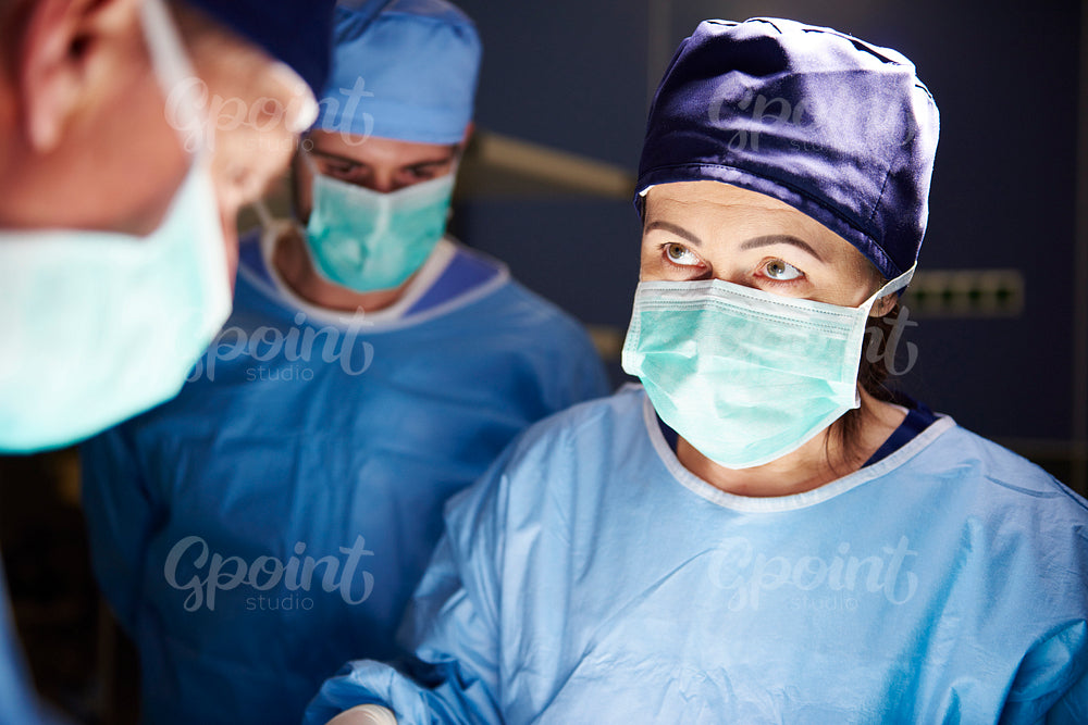 Surgeon during a very important operation in dark operating room