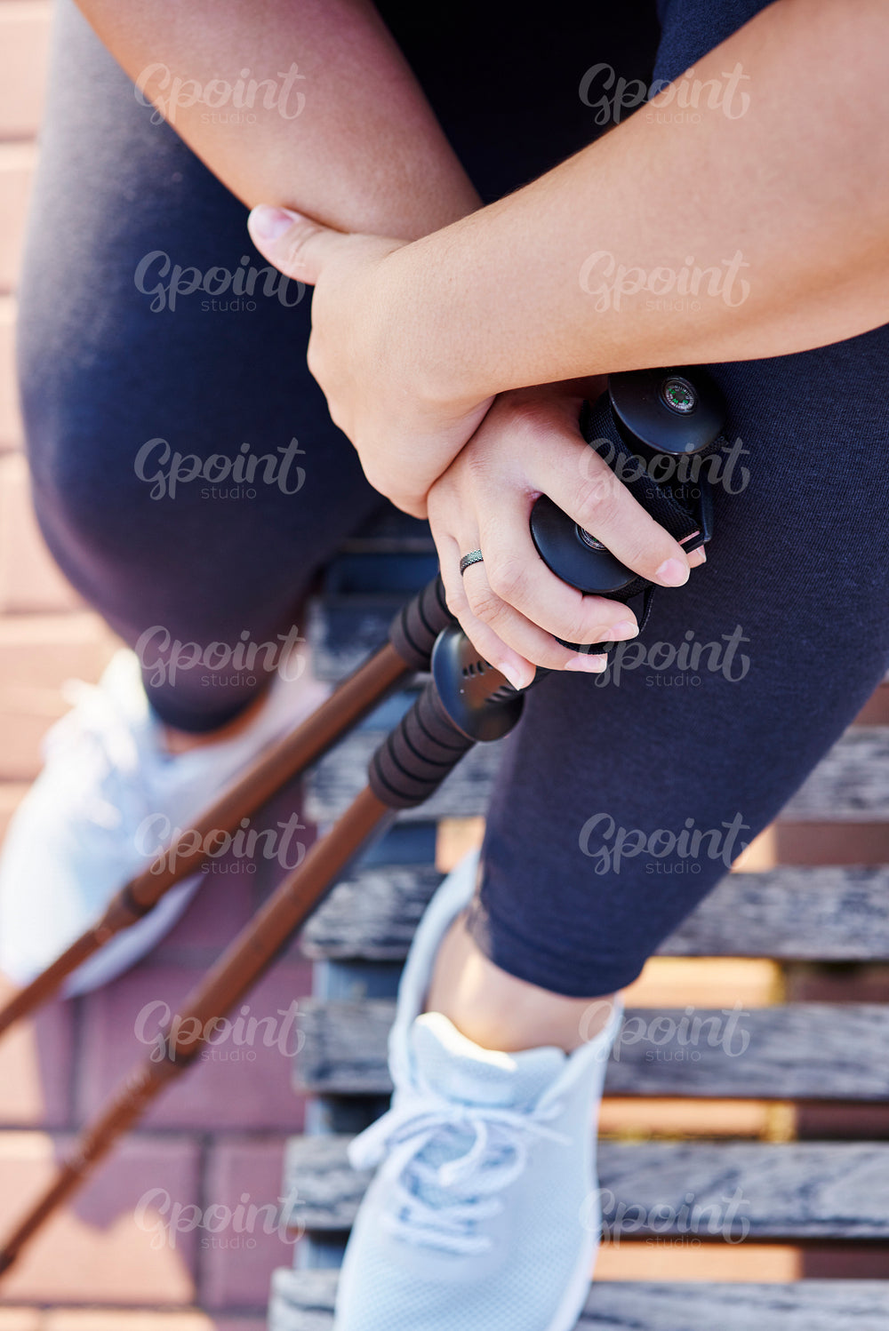 Low section of woman with hiking poles