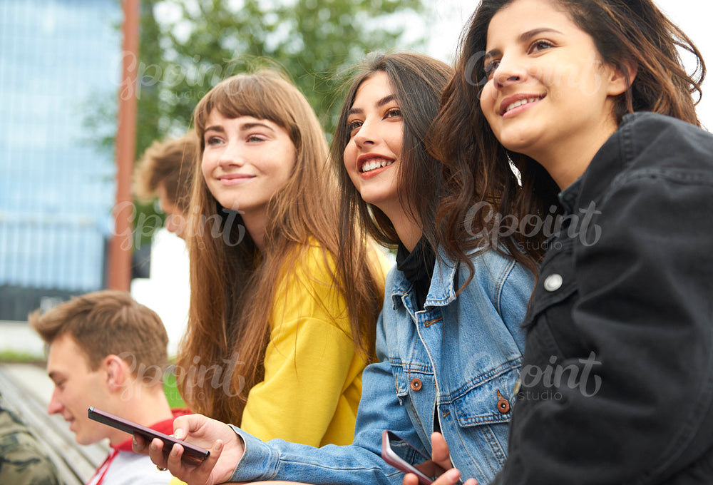 Three young women meeting in the city