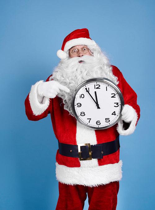 Worried santa claus holding clock