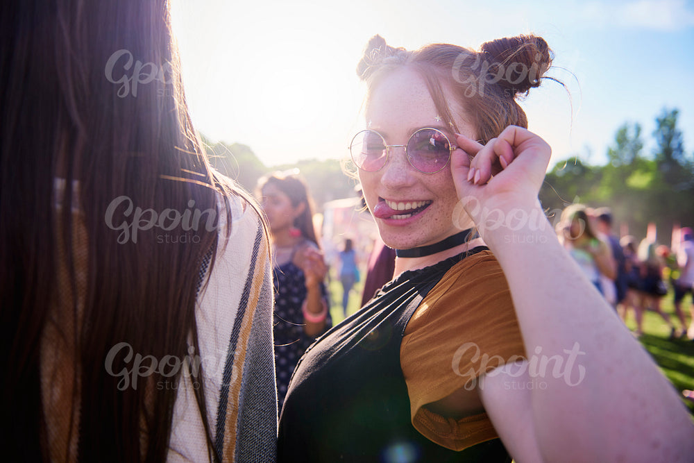 Portrait of young hippy woman in sunglasses at festival