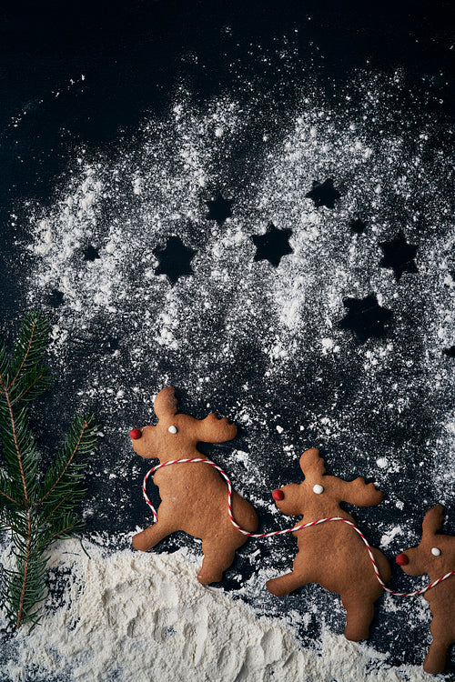 Vertical image of three reindeer gingerbread cookies