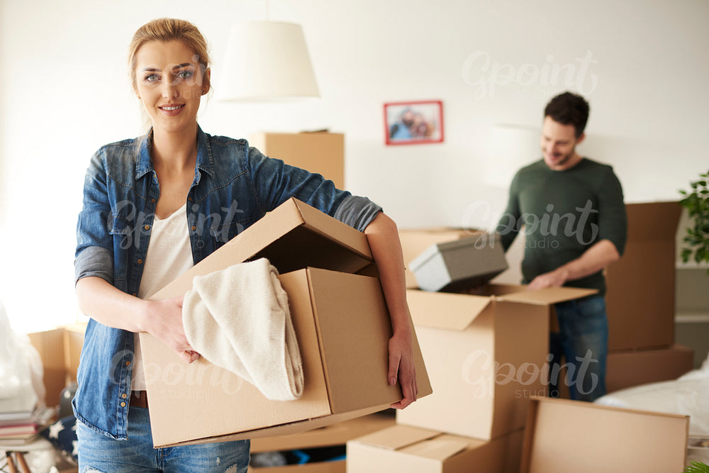 Woman helping her boyfriend while moving house