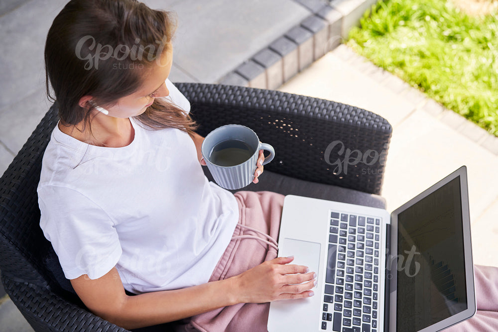 Busy woman working on laptop outdoors