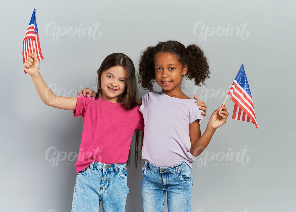 Two girls holding American flag